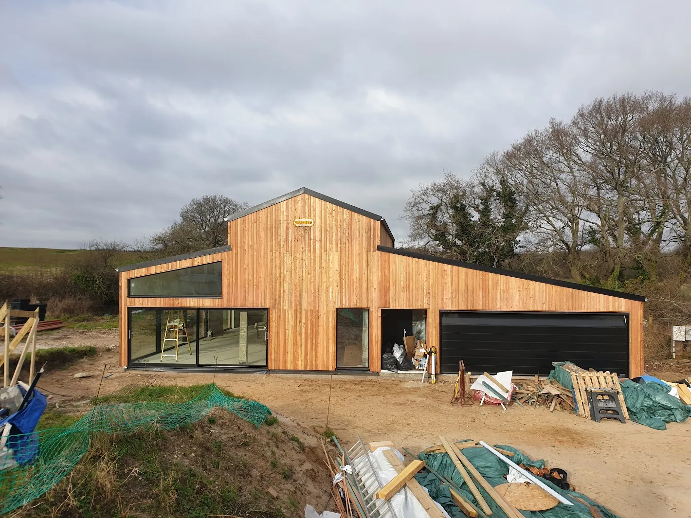 a large wooden building with a garage on top of it