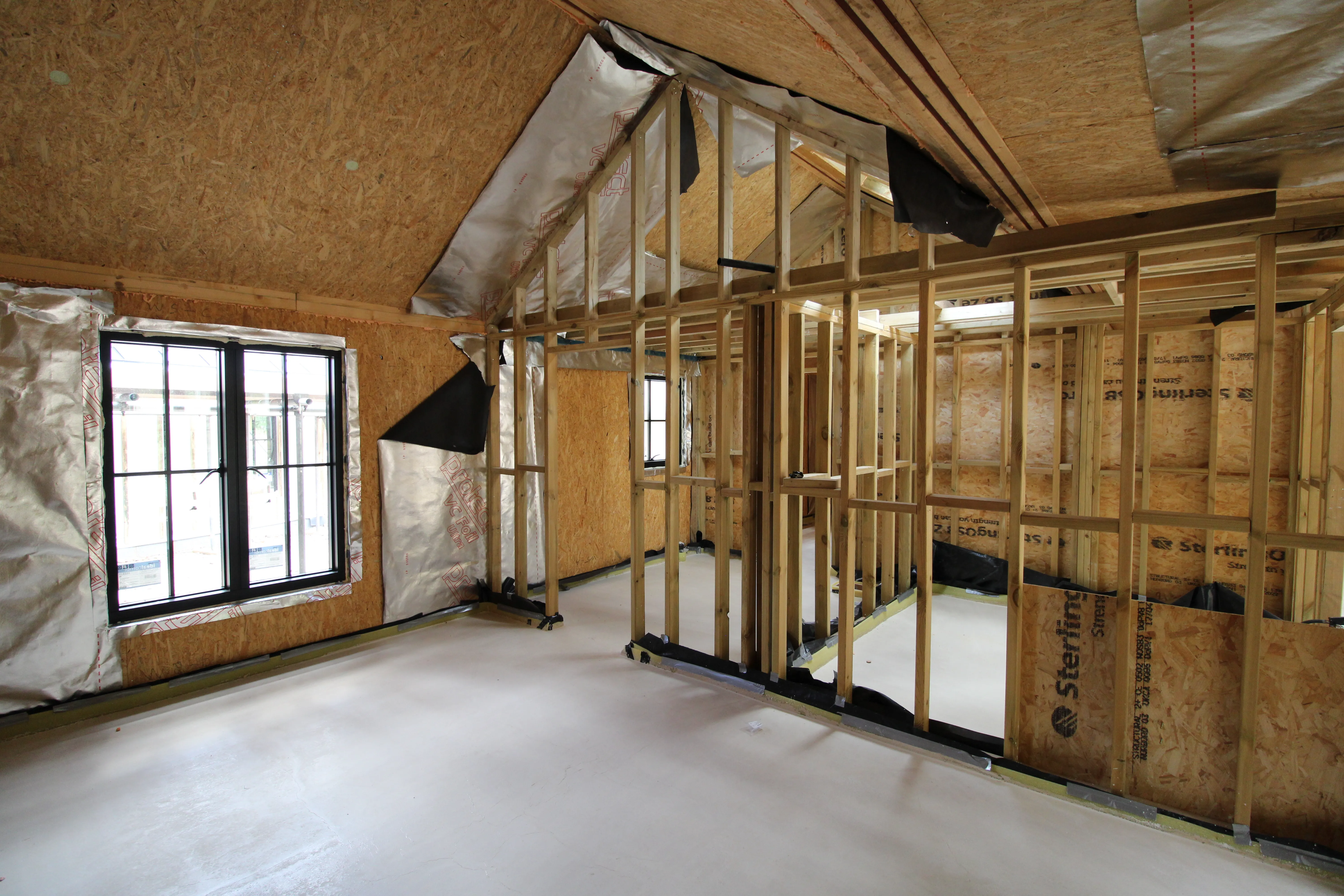 a room that is under construction with wood framing