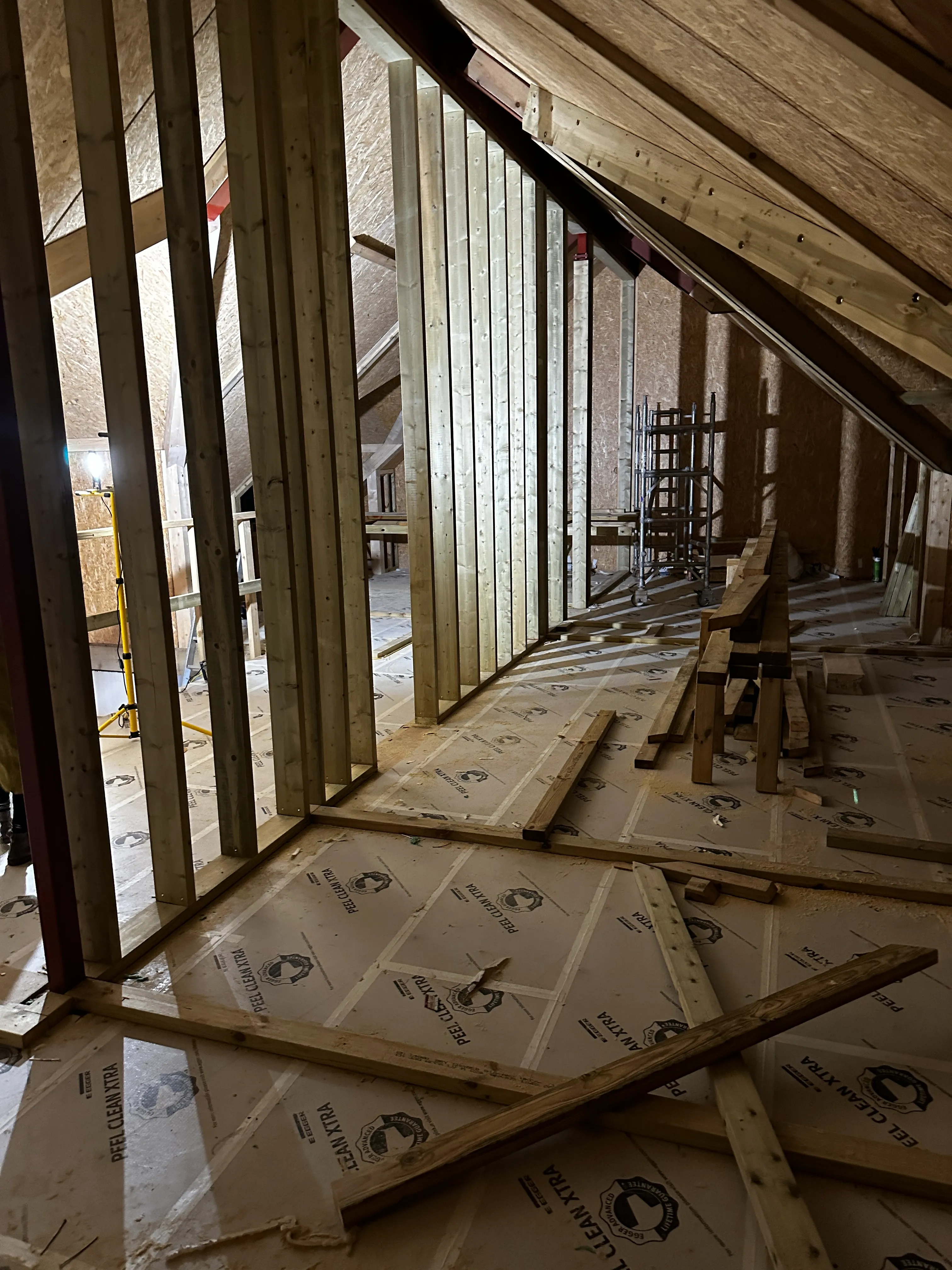 a room that is under construction with wooden framing