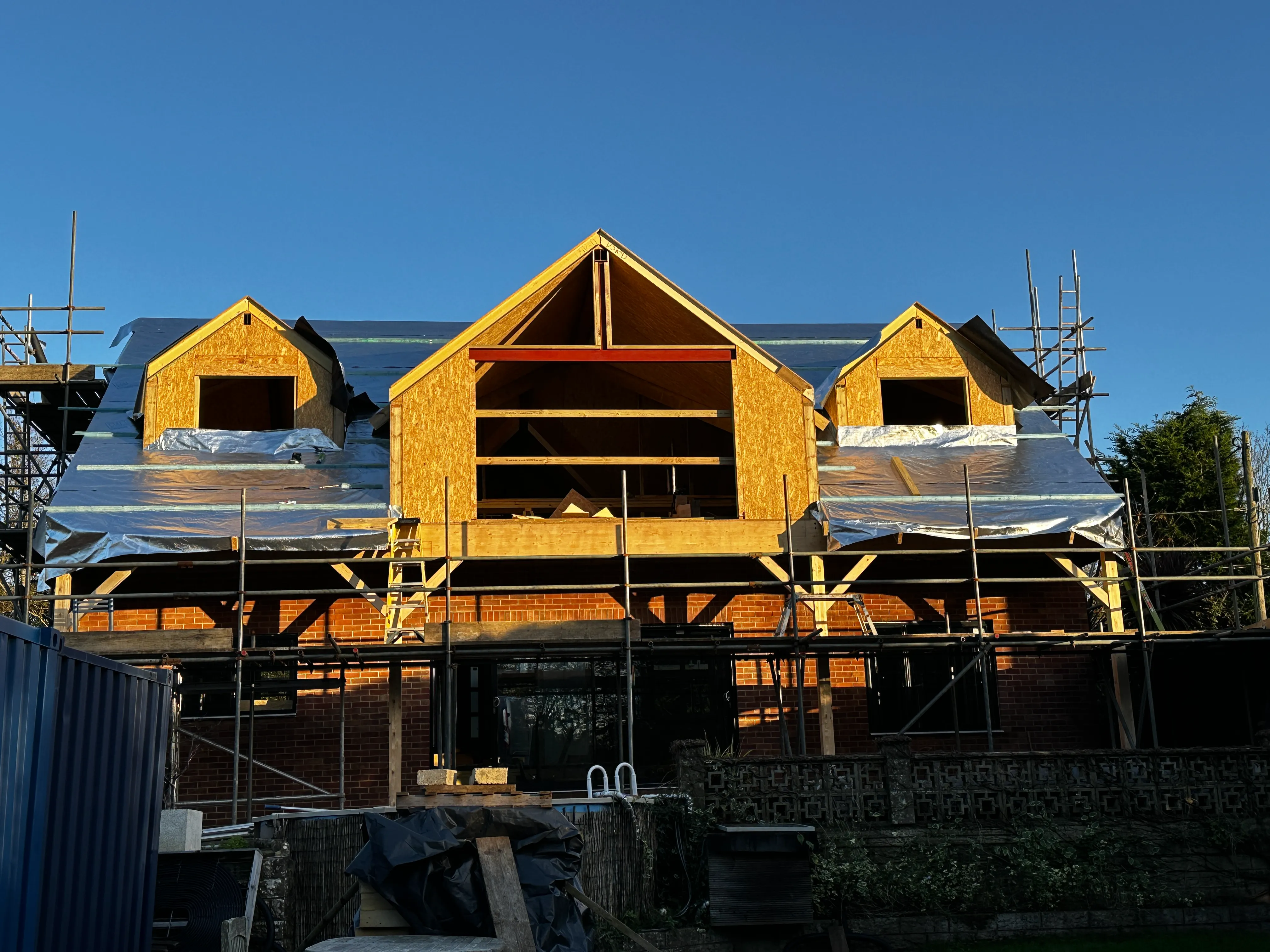 a house under construction with scaffolding on the roof